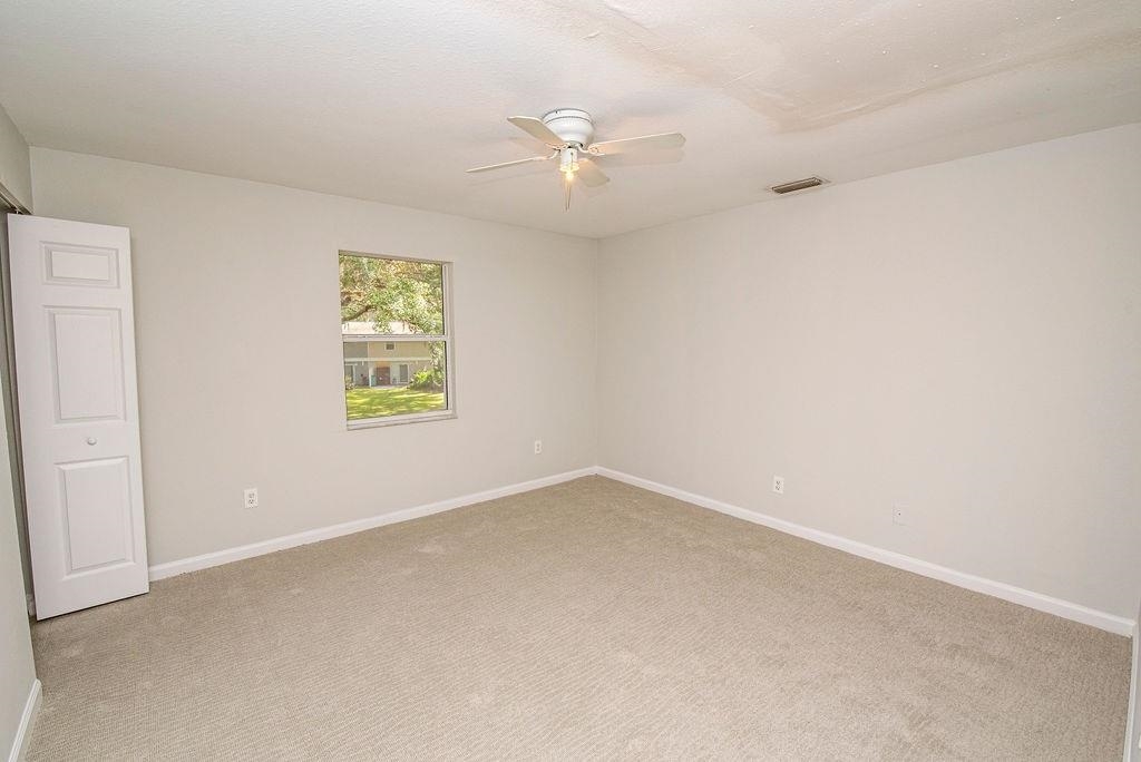 4420 Carter Road, Unit 44 St. Augustine, FL 32086 - Photo 16 of 18 an empty room with a window and a fan
