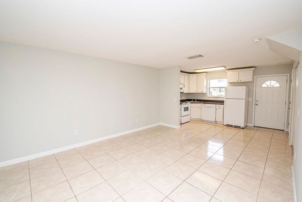 4420 Carter Road, Unit 44 St. Augustine, FL 32086 - Photo 6 of 18 a view of kitchen with granite countertop cabinets and white appliances
