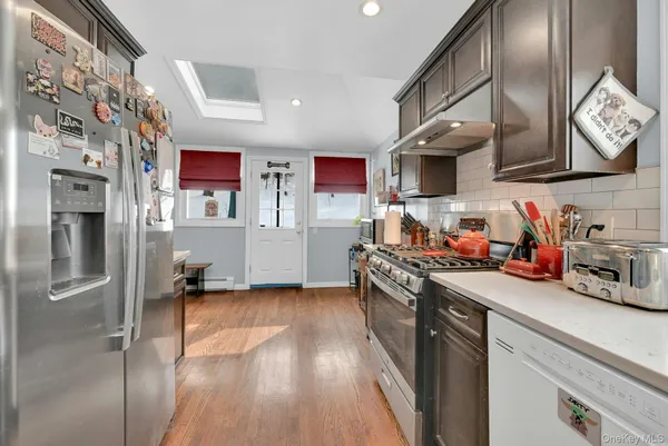 a kitchen with stainless steel appliances granite countertop a refrigerator stove and sink