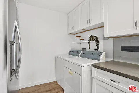 a utility room with sink dryer and washer