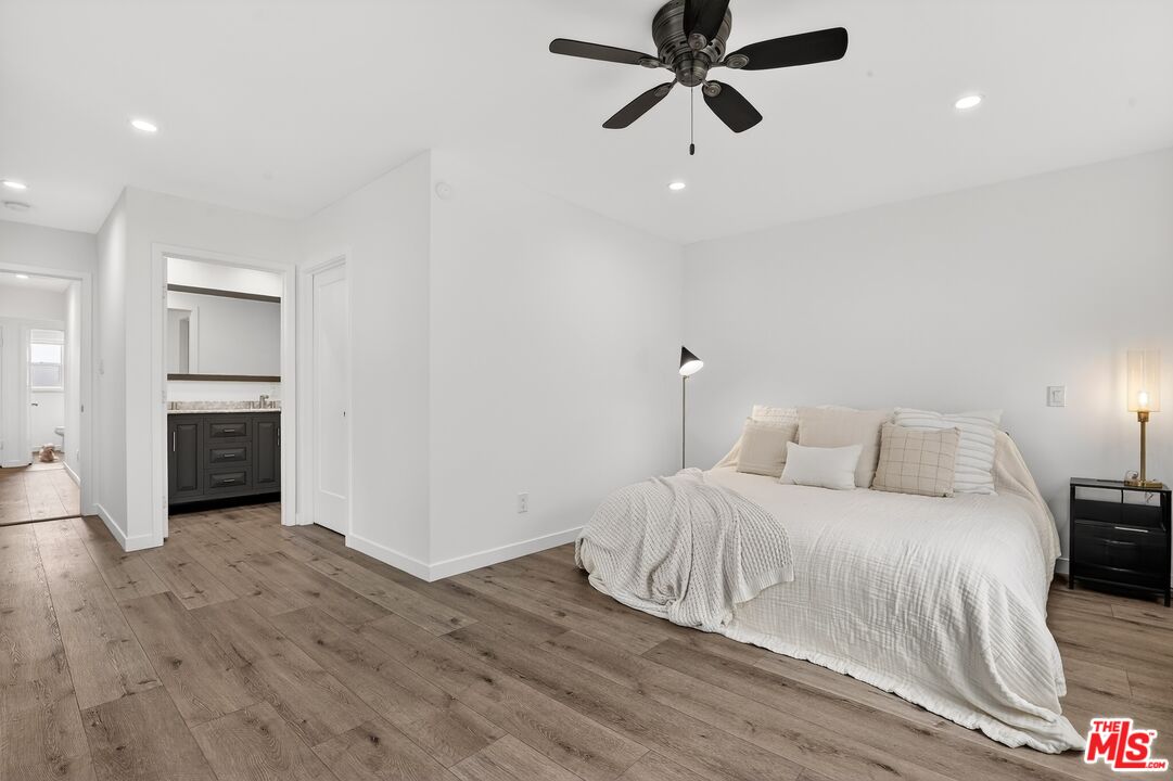 6565 Randi Avenue Woodland Hills, CA 91303 - Photo 13 of 25 a bedroom with a bed and a fireplace