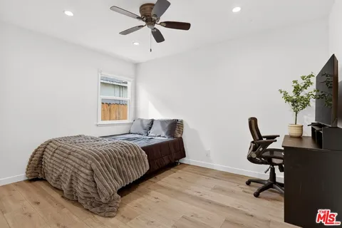 a bedroom with a bed a desk and chair