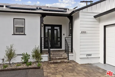 a view of front door and potted plants
