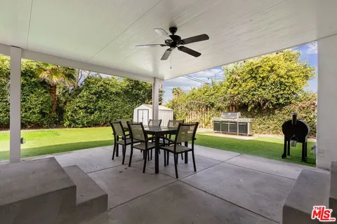 a view of a patio with a table chairs and a table