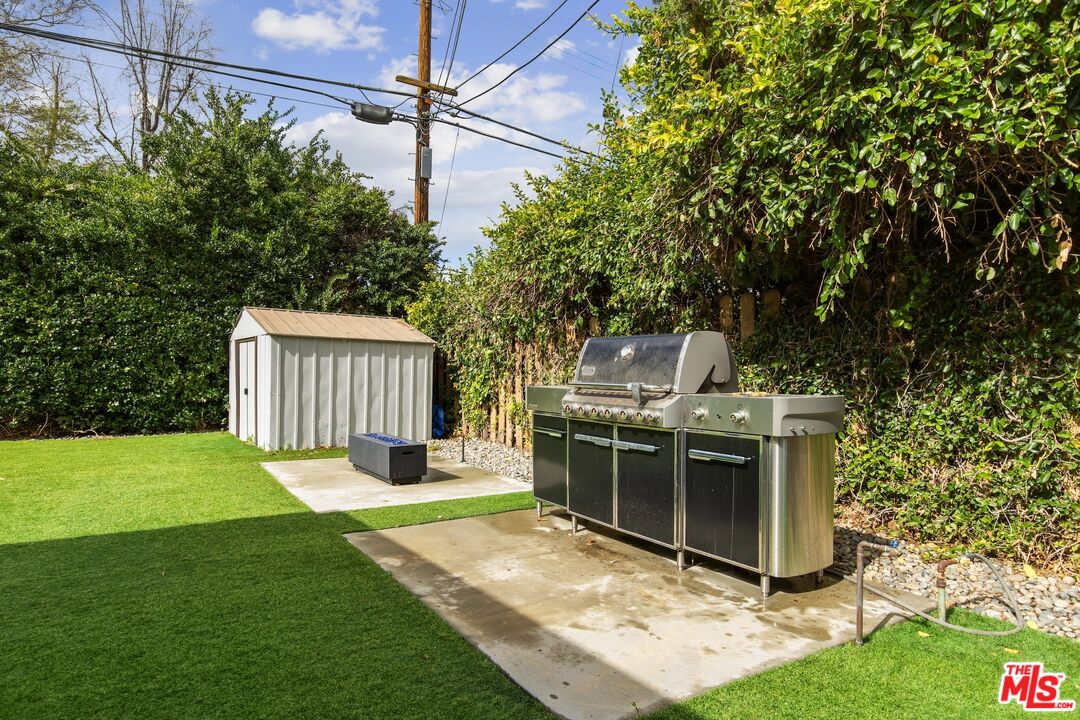 6565 Randi Avenue Woodland Hills, CA 91303 - Photo 23 of 25 a view of a backyard with a small cabin