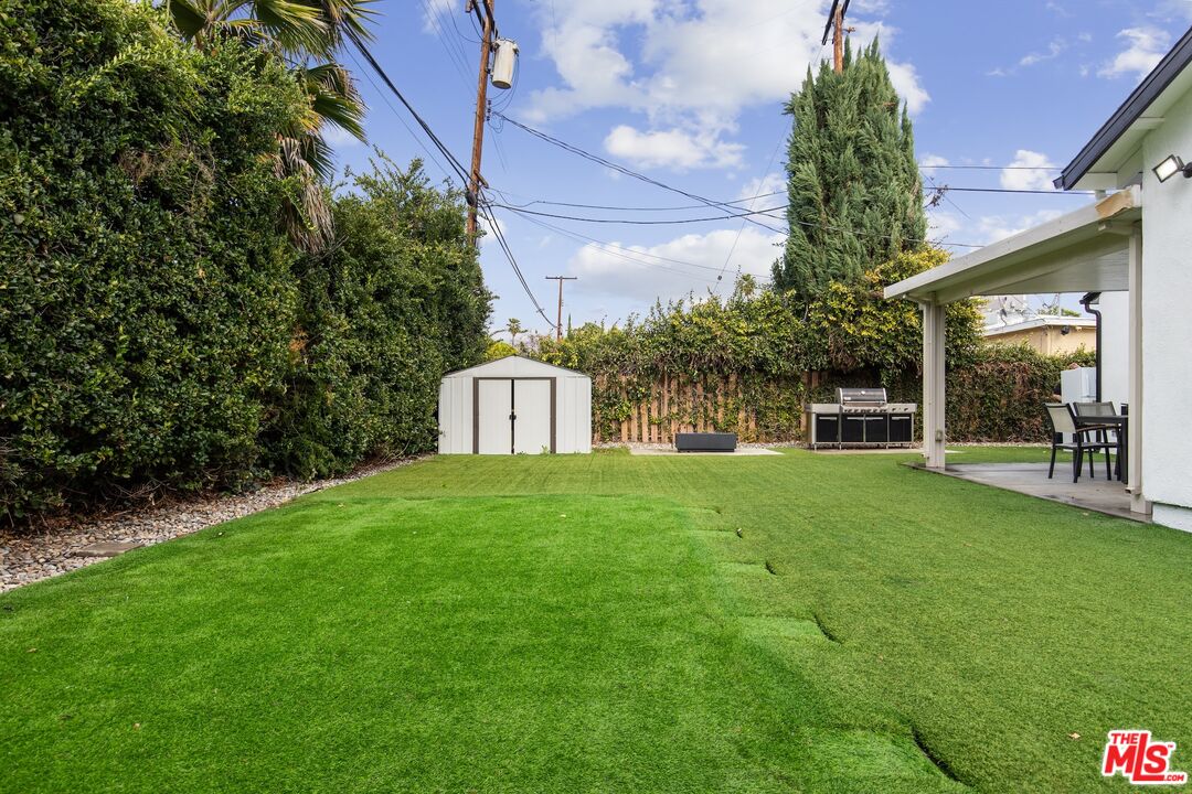 6565 Randi Avenue Woodland Hills, CA 91303 - Photo 25 of 25 a view of a house with a yard potted plants and a tree