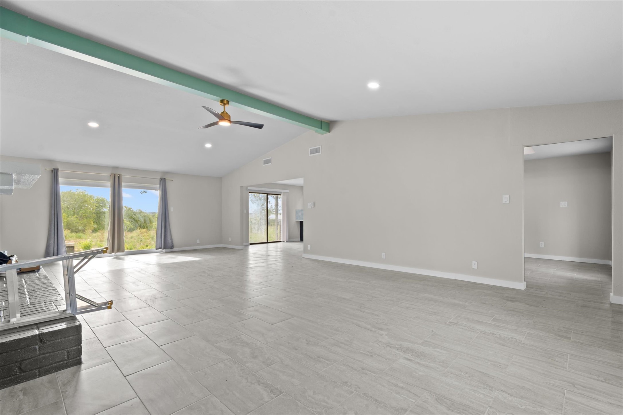9100 Highway 183 Austin, TX 78747 - Photo 38 of 38 An open floorplan connects versatile living areas under a vaulted ceiling with tile floors.
