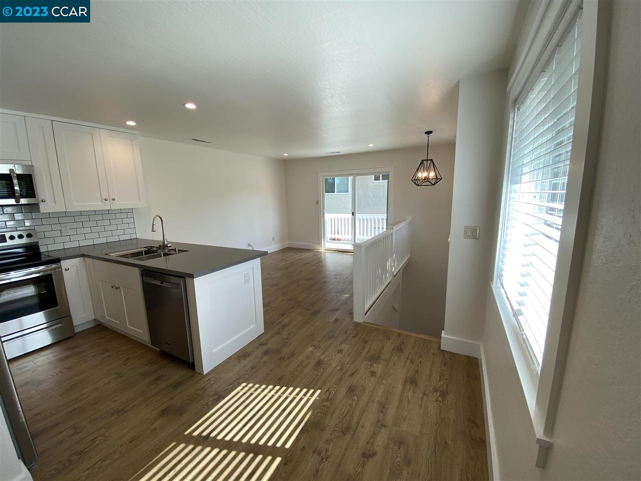 4882 San Pablo Dam Road, Unit B El Sobrante, CA 94803 - Photo 2 of 12 a kitchen with granite countertop a sink and a stove top oven