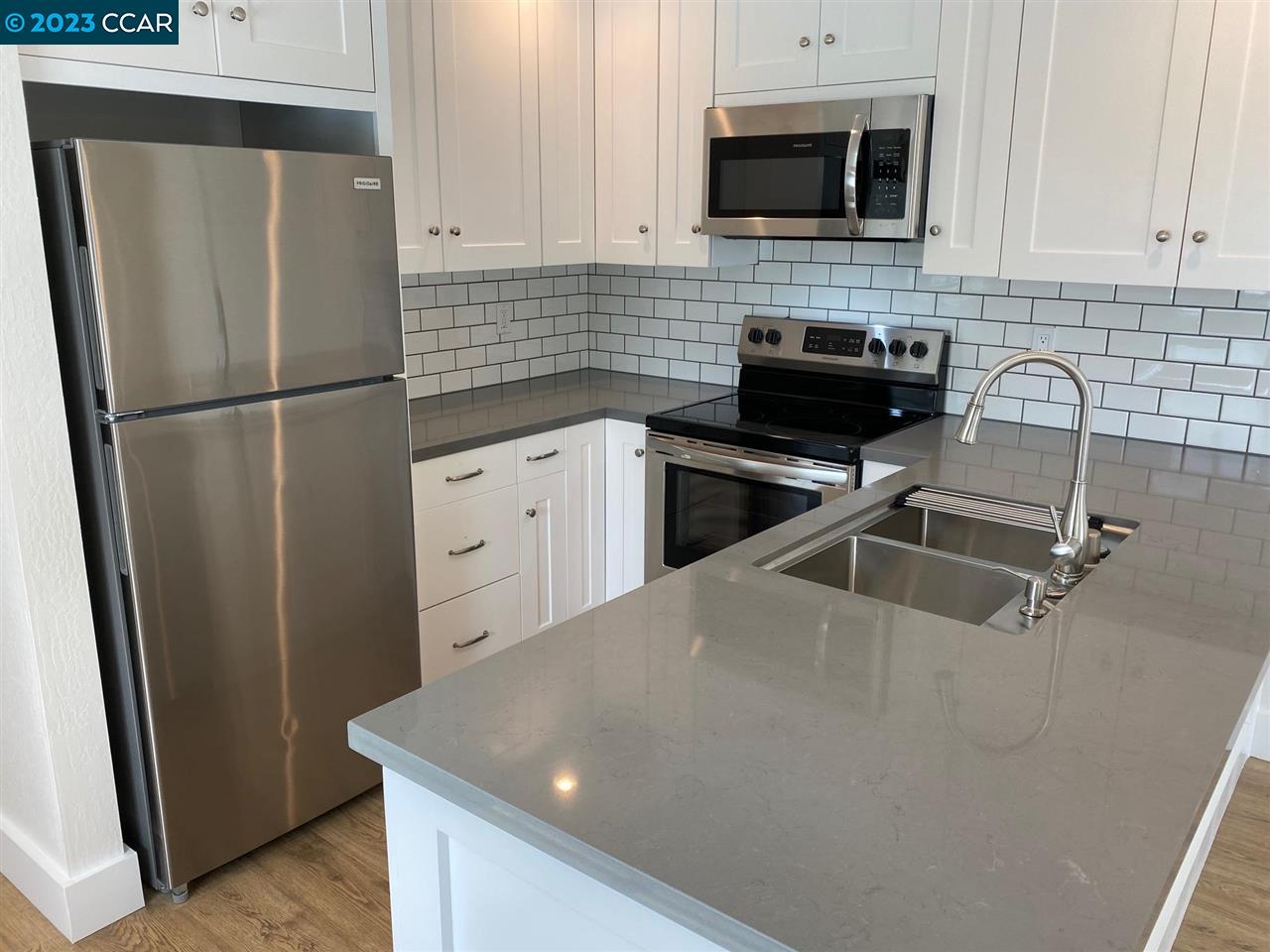 4882 San Pablo Dam Road, Unit B El Sobrante, CA 94803 - Photo 3 of 12 a kitchen with stainless steel appliances a refrigerator sink and microwave