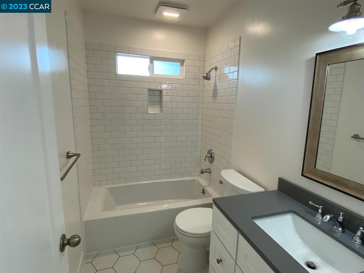 4882 San Pablo Dam Road, Unit B El Sobrante, CA 94803 - Photo 7 of 12 a bathroom with a sink a toilet and shower