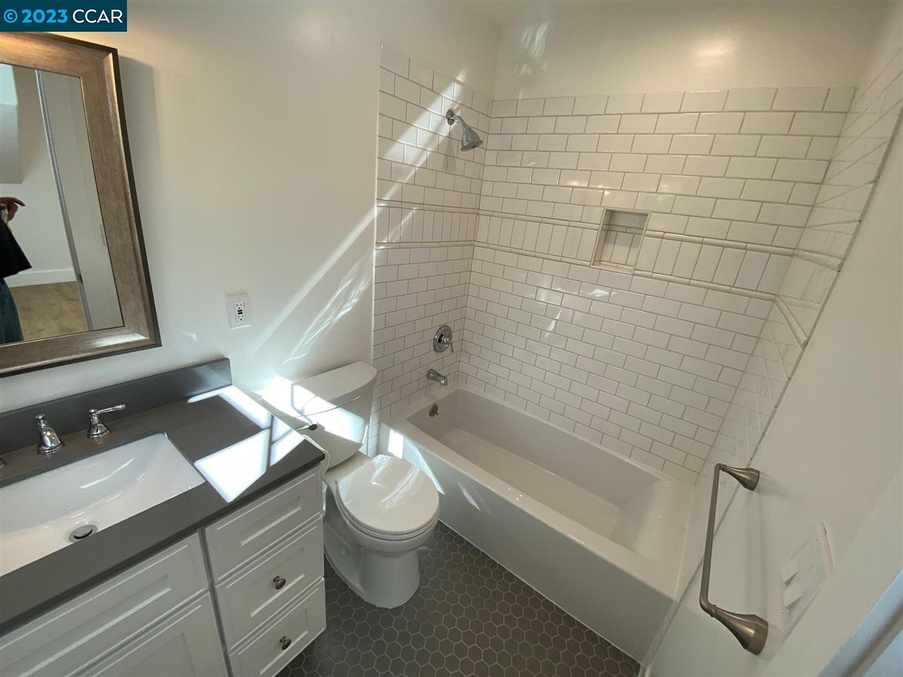 4882 San Pablo Dam Road, Unit B El Sobrante, CA 94803 - Photo 9 of 12 a bathroom with a granite countertop bathtub shower sink vanity and toilet