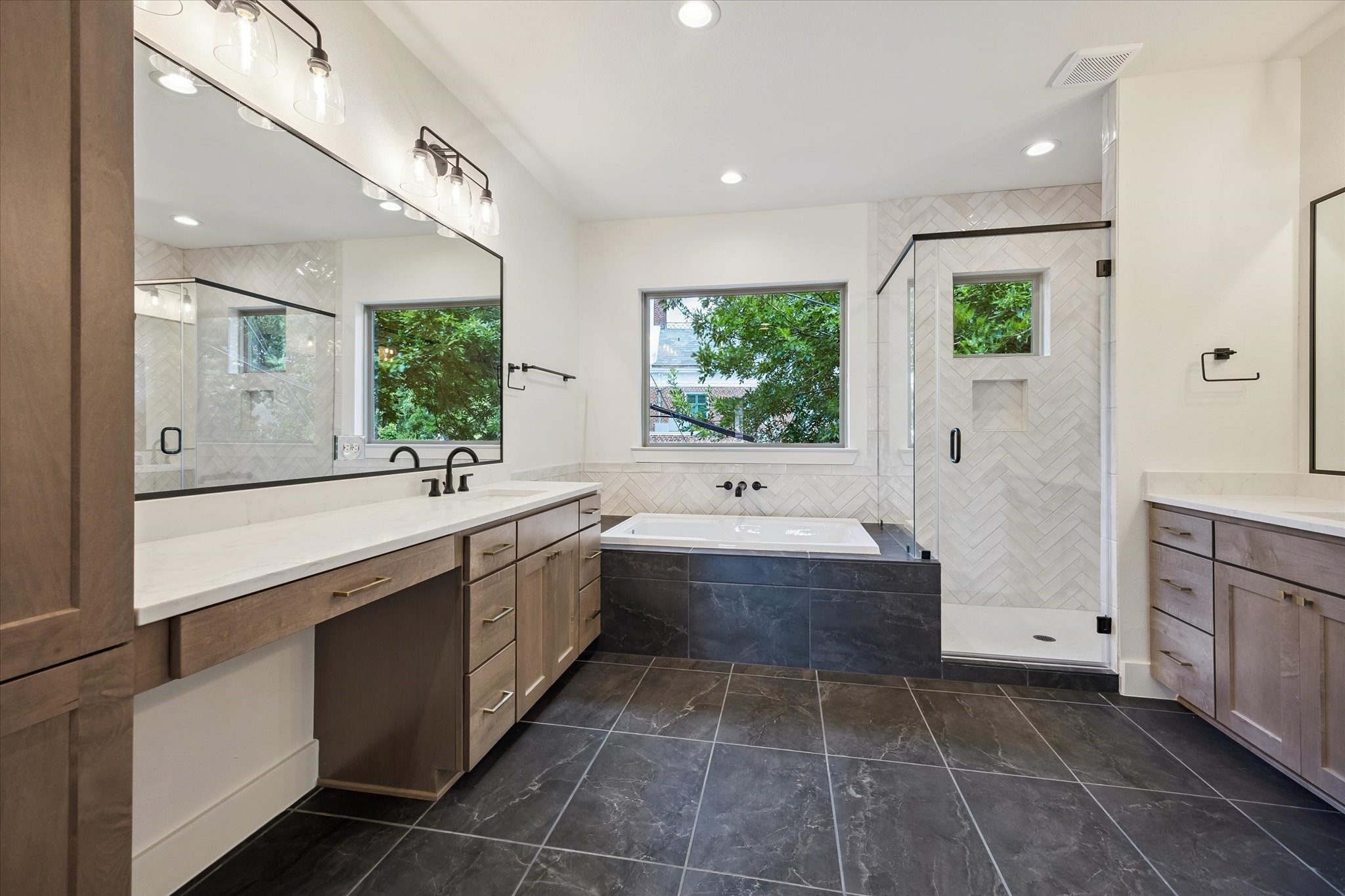 5329 Dora Street Houston, TX 77005 - Photo 24 of 43 A spa-like primary suite featuring a lavish 5-piece bath with dual vanities, a deep soaking tub, and a separate glass-enclosed shower leading into a spacious walk-in closet designed for extensive wardrobes.