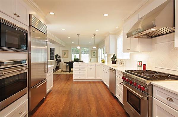 312 Dean Road Brookline, MA 02445 - Photo 5 of 11 a kitchen with stainless steel appliances kitchen island granite countertop a stove a sink and a refrigerator