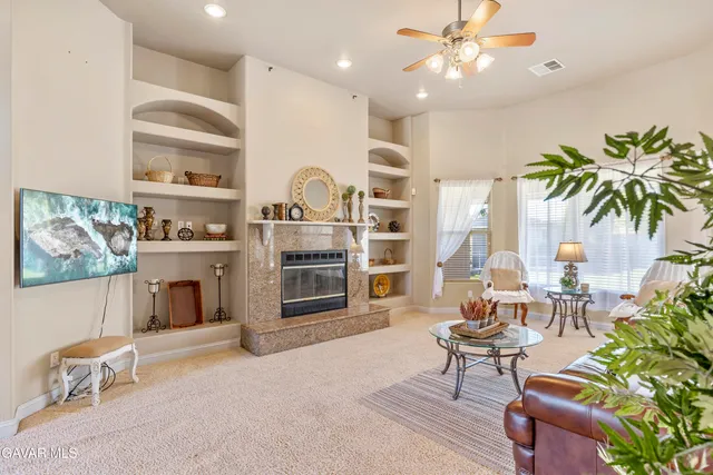 a dining room with furniture a chandelier and wooden floor