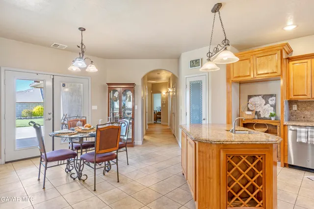 a living room with furniture a fireplace and a chandelier