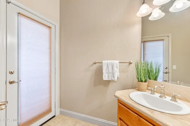 a bedroom with two beds and a chandelier