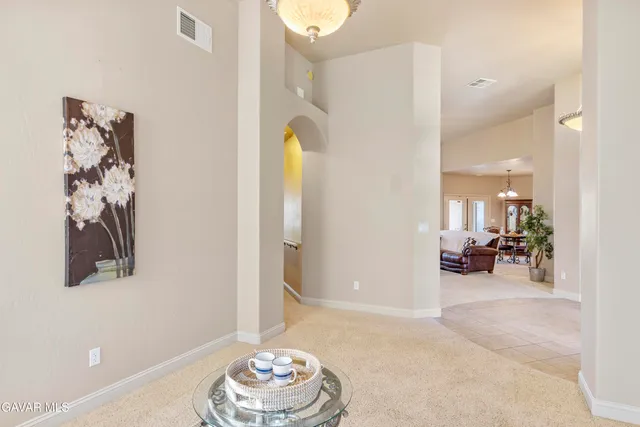 a bedroom with a bed a dresser and mirror