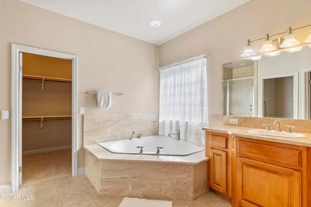 a bathroom with a tub and a shower