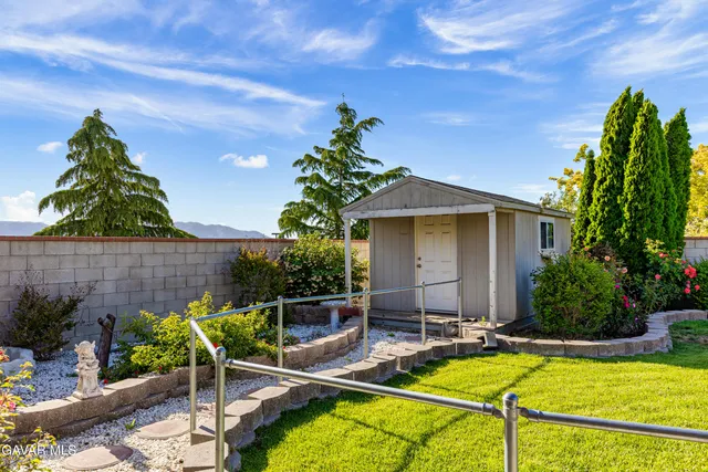 a view of a house with a yard and sitting area