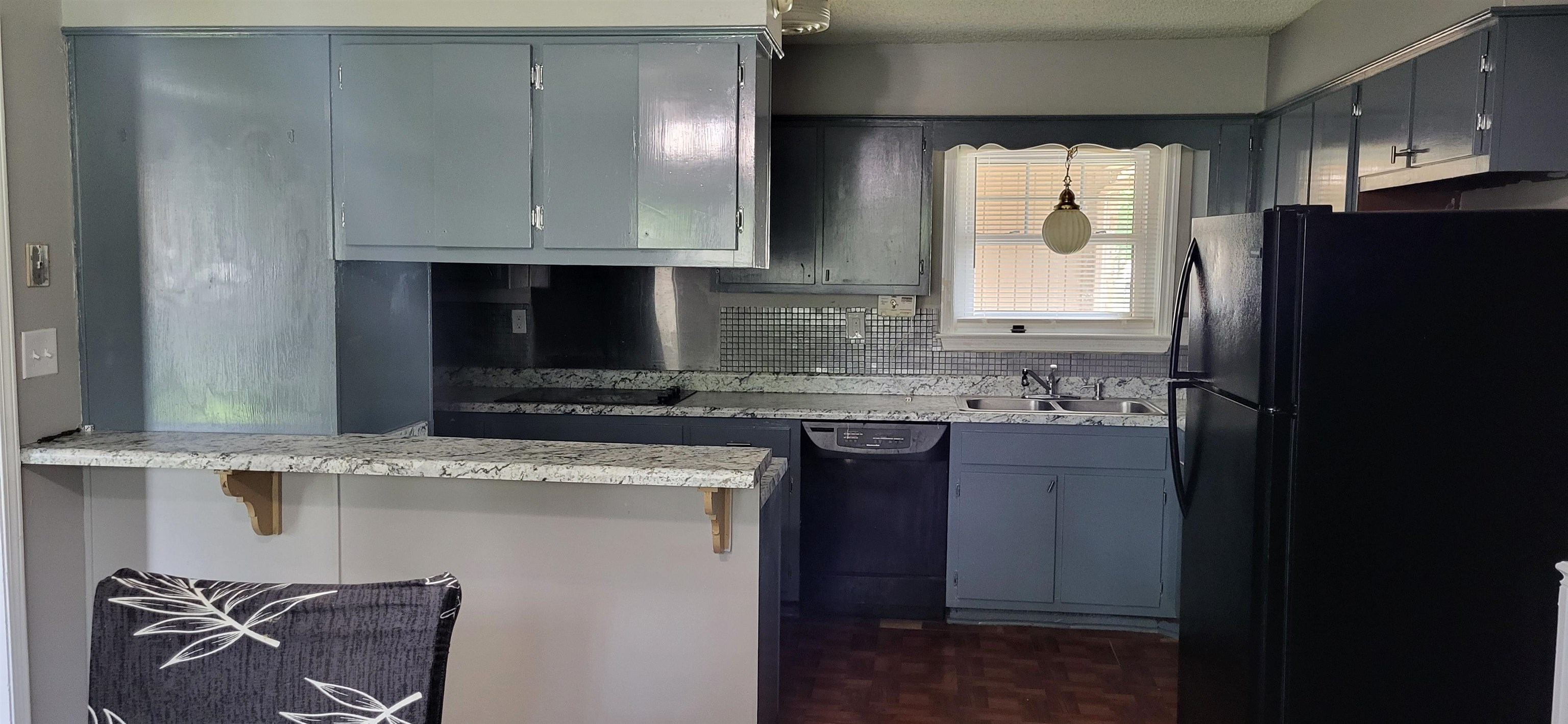 4567 Crump Road Memphis, TN 38141 - Photo 11 of 28 a kitchen with a sink a refrigerator and cabinets