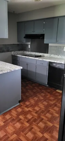 a kitchen with stainless steel appliances granite countertop a sink stove and cabinets
