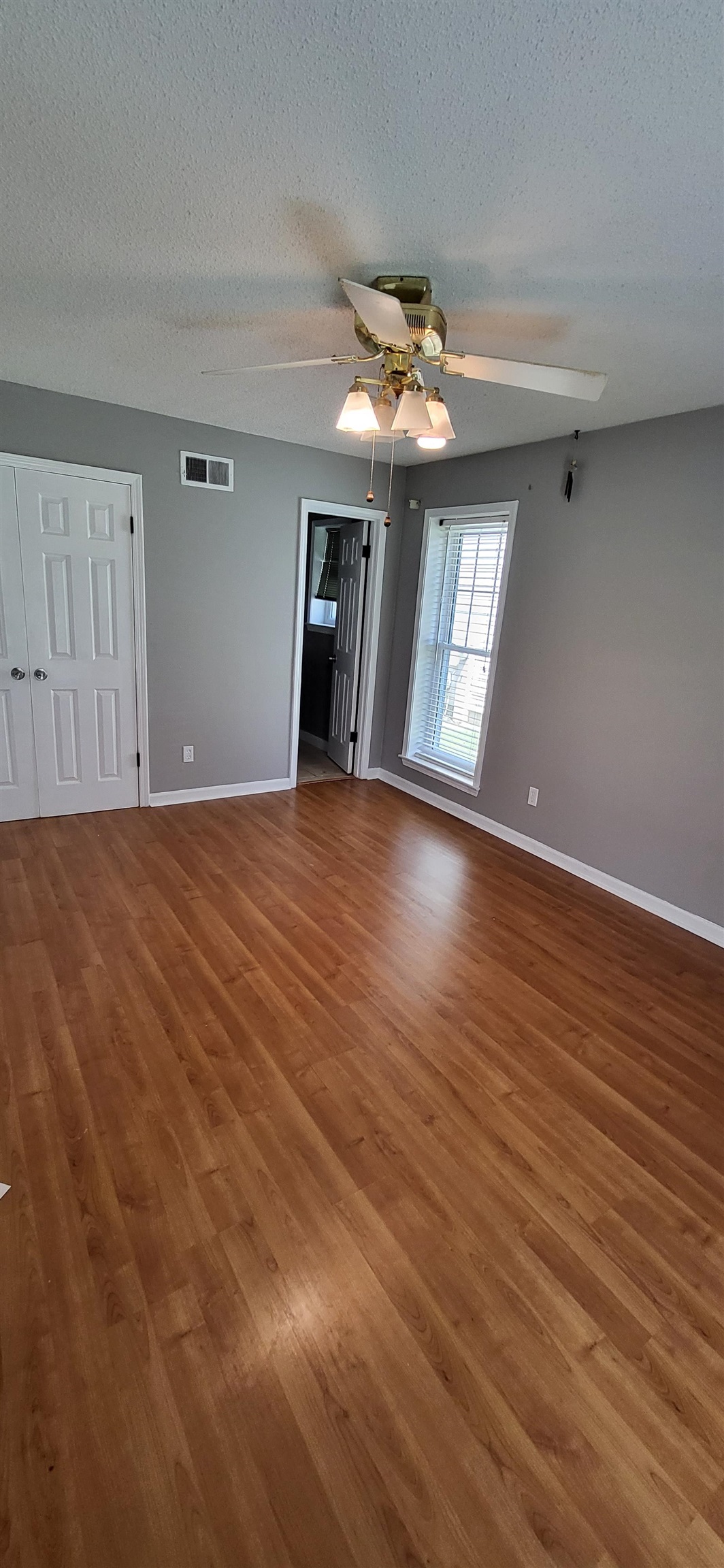 4567 Crump Road Memphis, TN 38141 - Photo 16 of 28 Unfurnished room with a ceiling fan, wood finished floors, and a textured ceiling