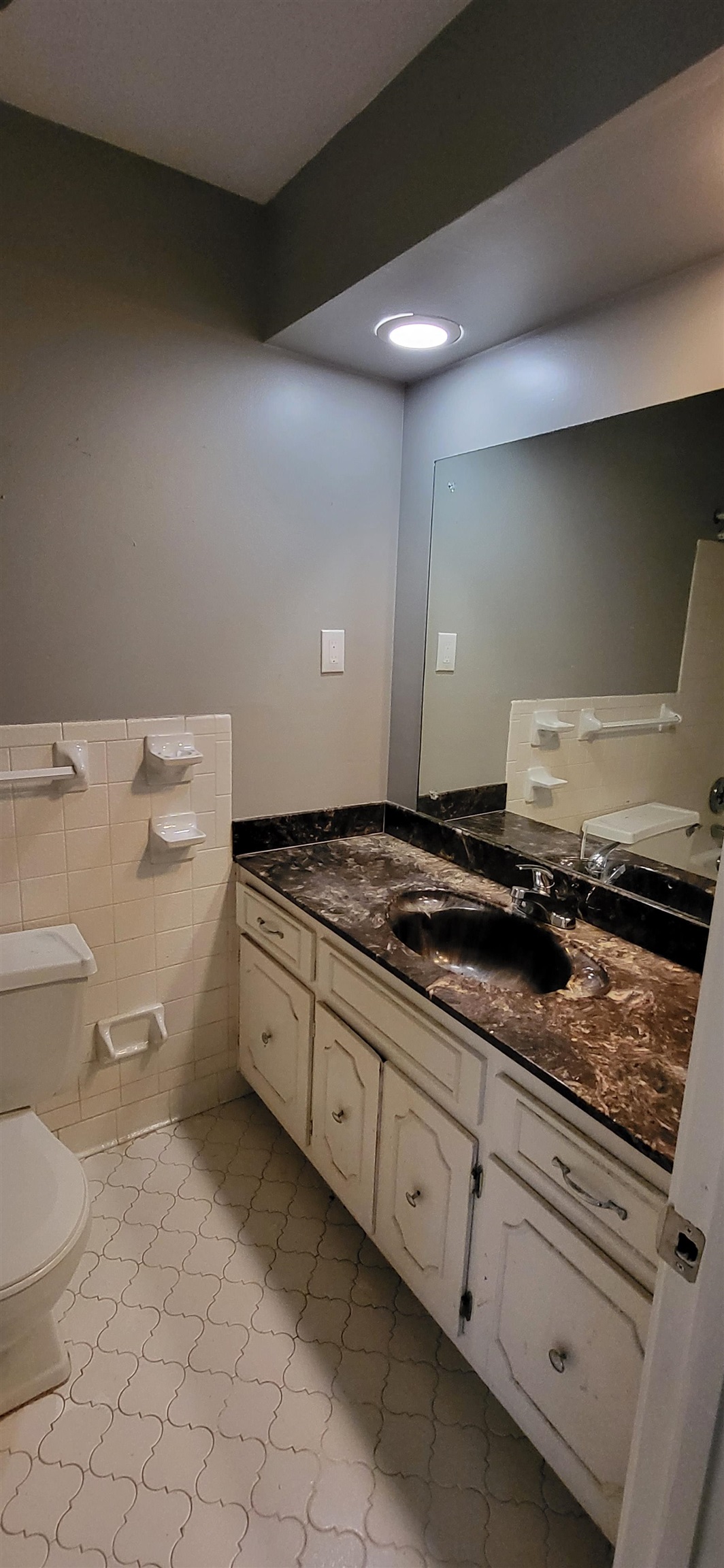 4567 Crump Road Memphis, TN 38141 - Photo 19 of 28 Bathroom with vanity, tile walls, and a wainscoted wall