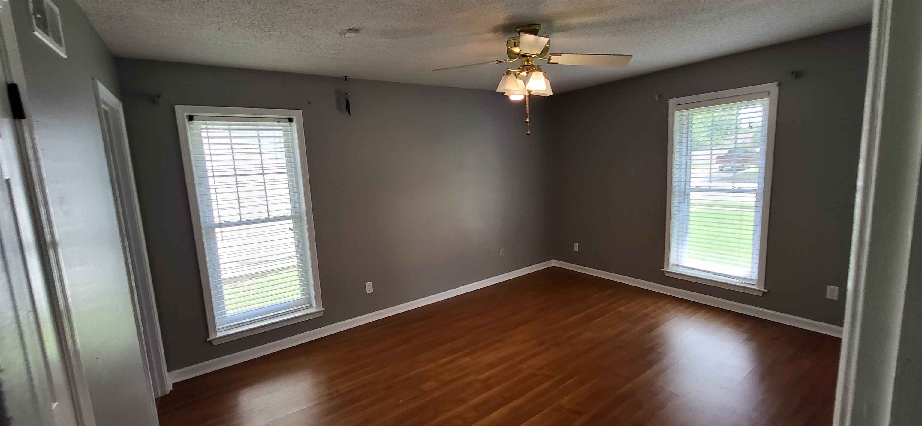 4567 Crump Road Memphis, TN 38141 - Photo 20 of 28 an empty room with wooden floor and windows