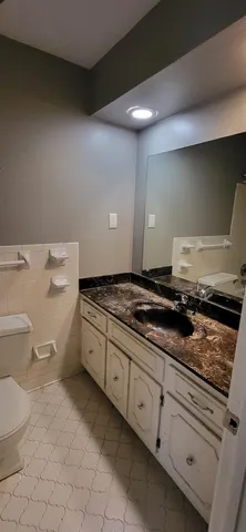 a kitchen with a stove and white cabinets