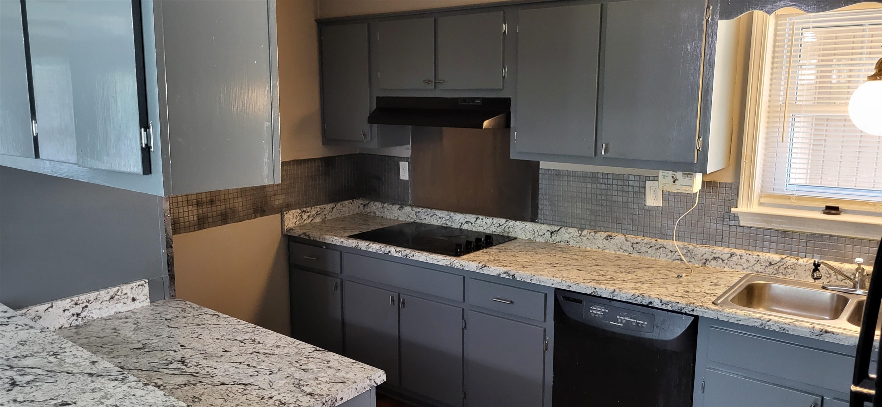 4567 Crump Road Memphis, TN 38141 - Photo 26 of 28 Kitchen with black appliances, ventilation hood, gray cabinetry, and decorative backsplash