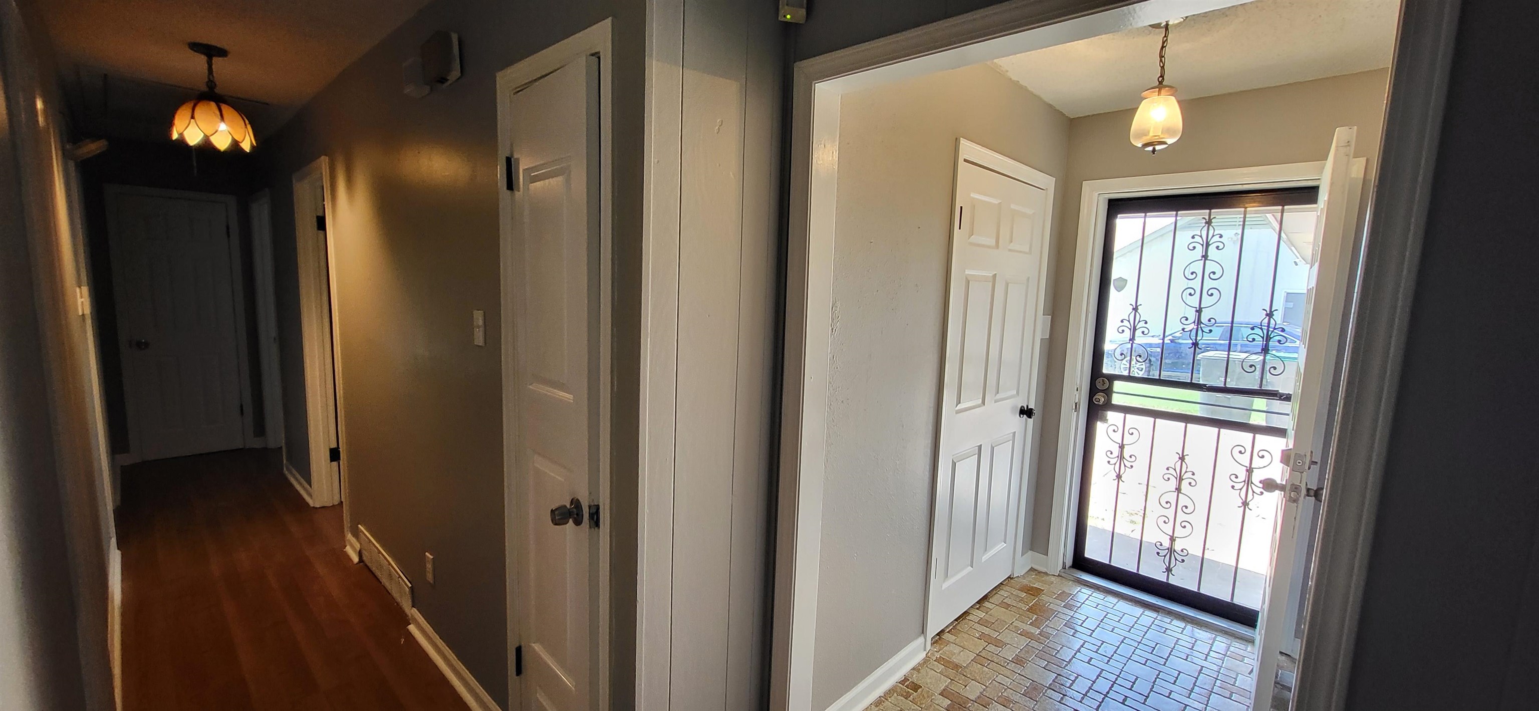 4567 Crump Road Memphis, TN 38141 - Photo 6 of 28 a view of a hallway with wooden floor and a chandelier