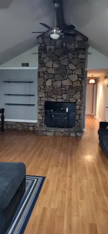 a room with wooden floor and a fireplace