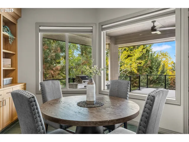 a dining room with furniture window and wooden floor