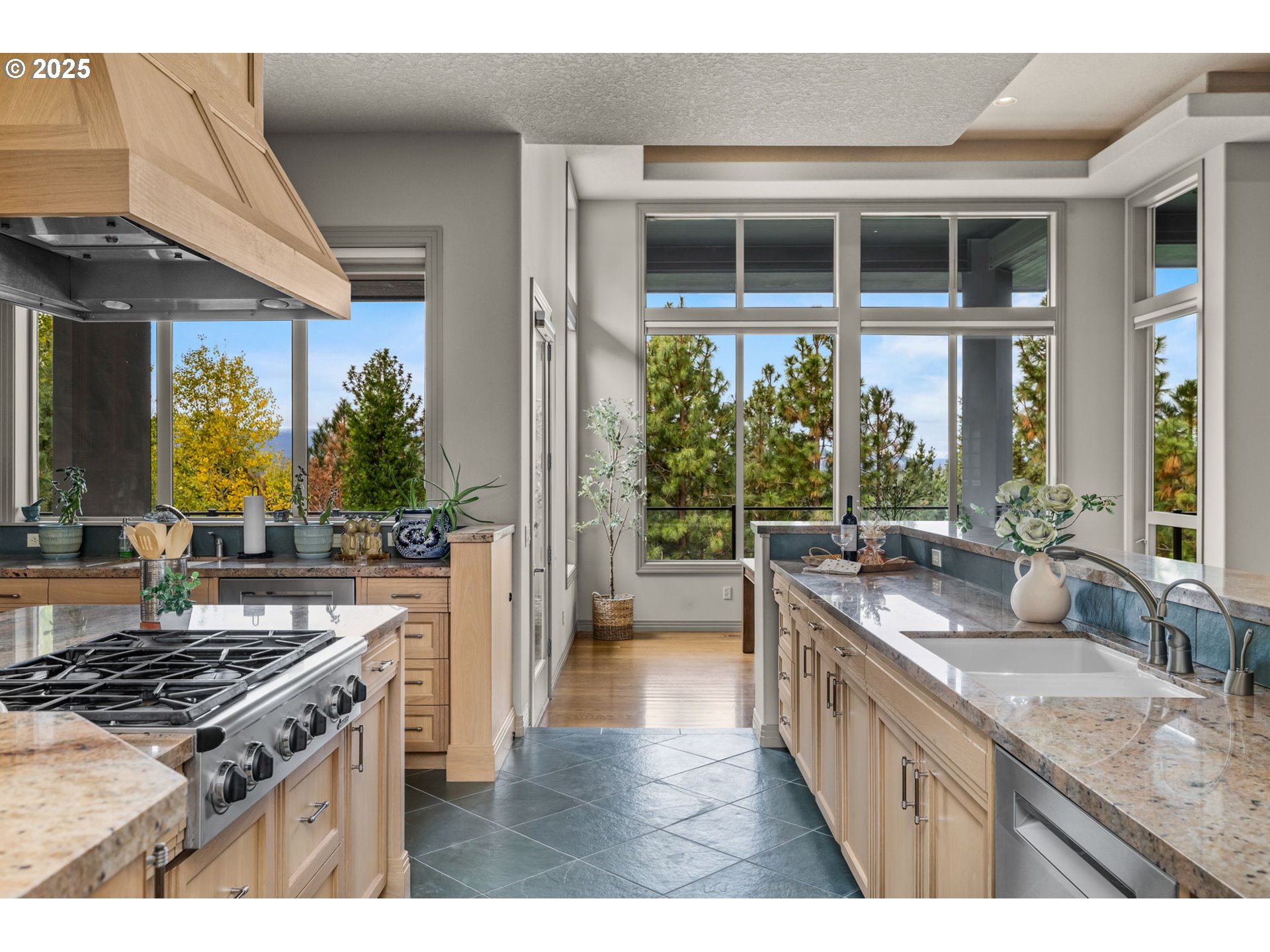 3155 Northwest Metke Place Bend, OR 97703 - Photo 13 of 28 a kitchen with stainless steel appliances granite countertop a stove a sink and a wooden cabinets