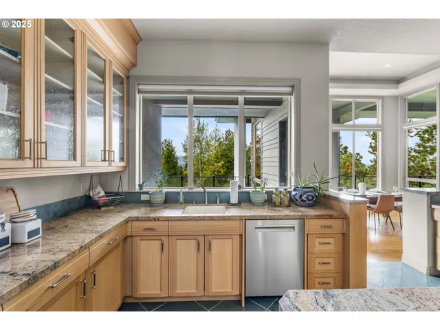 a kitchen with sink and large window