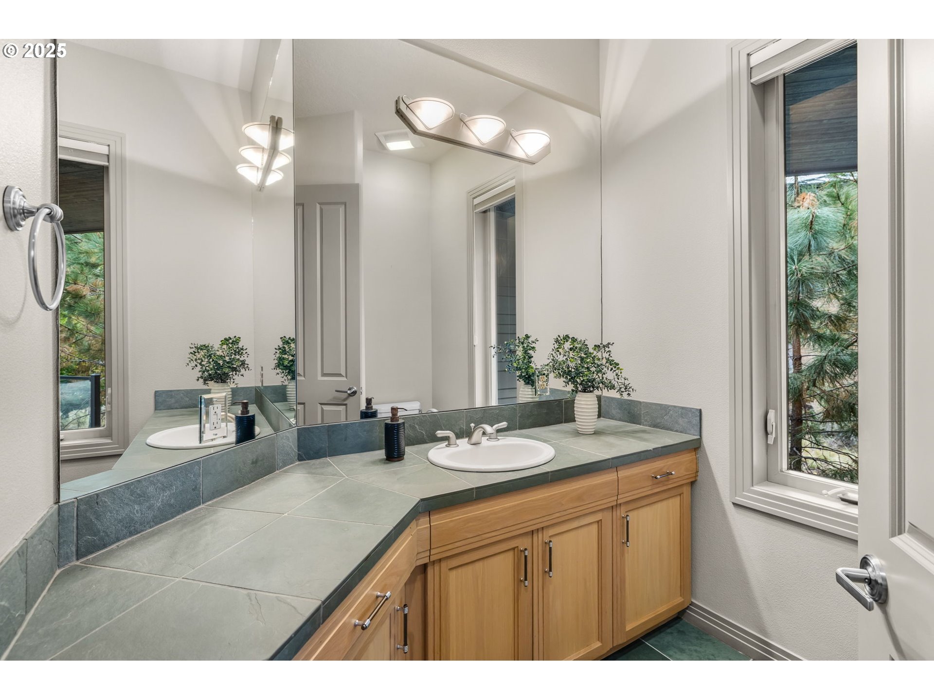 3155 Northwest Metke Place Bend, OR 97703 - Photo 16 of 28 a bathroom with a sink a vanity and a mirror