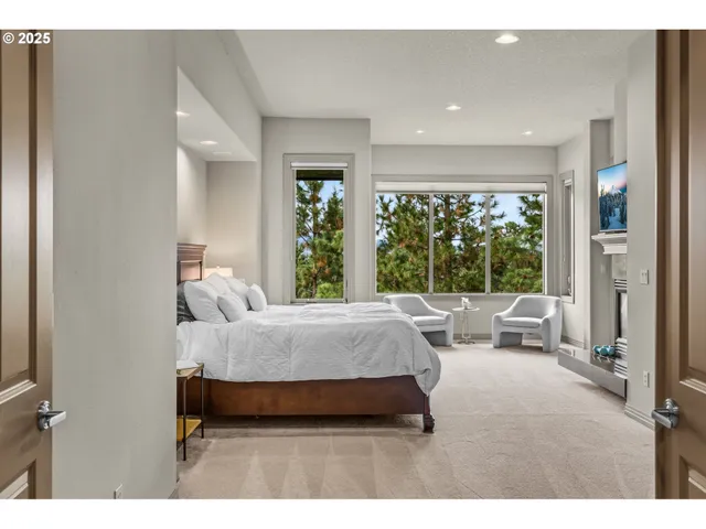 a living room with furniture and large windows