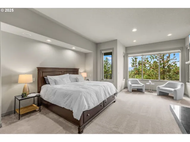 a bedroom with a bed and large window