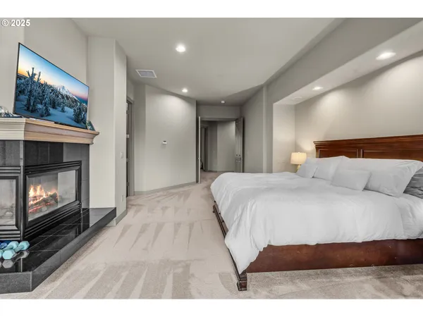 a spacious bedroom with a bed and a fireplace