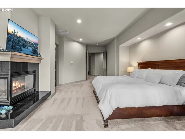 a spacious bedroom with a bed and a fireplace