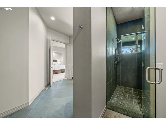 a bathroom with a glass shower door