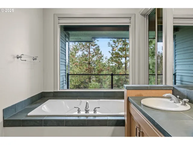 a view of bathroom with bathtub and window