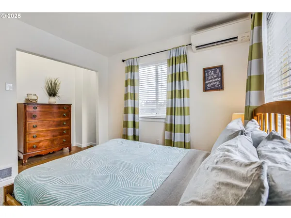 a bedroom with a bed and a dresser