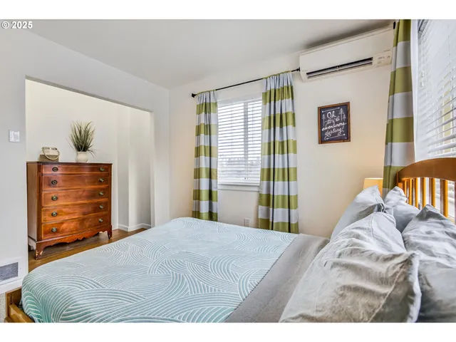 a bedroom with a bed and a dresser