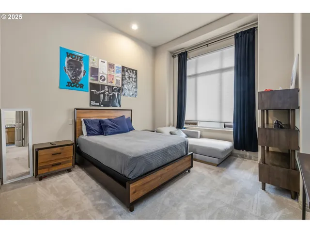 a bedroom with a bed wooden floor and window