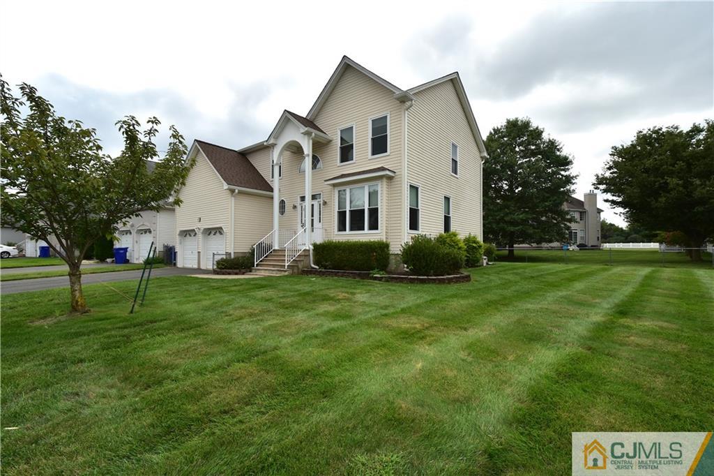 1 Timber Ridge Road North Brunswick, NJ 08902 - Photo 2 of 38 a white house with a small yard and big trees