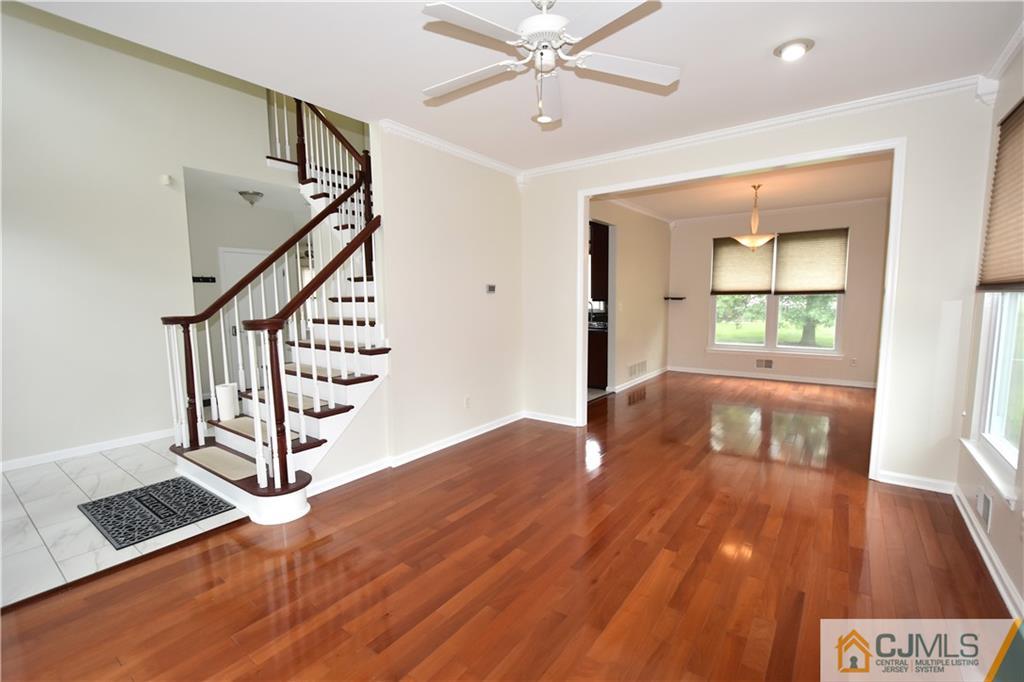 1 Timber Ridge Road North Brunswick, NJ 08902 - Photo 5 of 38 a view of an empty room with wooden floor and a window