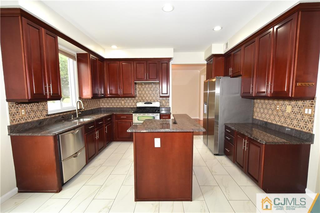 1 Timber Ridge Road North Brunswick, NJ 08902 - Photo 10 of 38 a kitchen with stainless steel appliances granite countertop a stove a refrigerator a sink and dishwasher