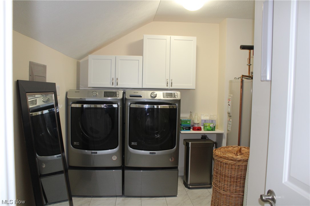 122 Turtle Bay Huron, OH 44839 - Photo 27 of 31 Clothes washing area featuring water heater, light tile flooring, cabinets, and washer and dryer