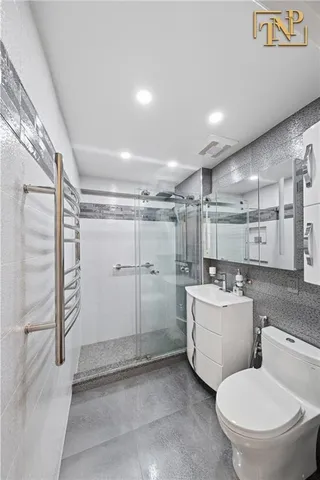 a bathroom with a toilet sink and shower